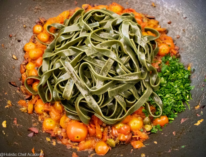 add the spirulina pasta to the puttanesca sauce