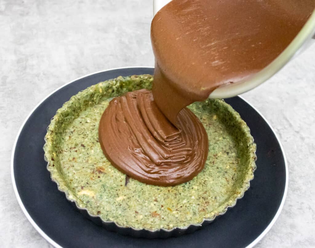 adding the raw cheesecake mix to base