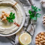 chickpea hummus served garnished with cumin powder, chill, olive oil and parsley