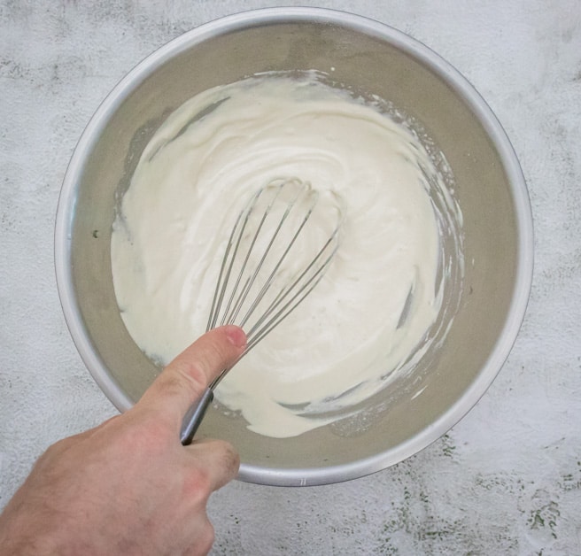 whisking sesame seed paste for the perfect creamy hummus