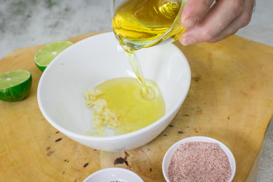 adding olive oil to the sauce for tabbouleh