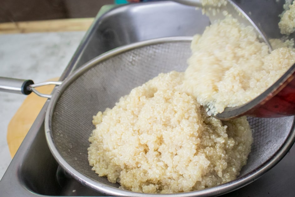 drain quinoa over a strainer after cooking 