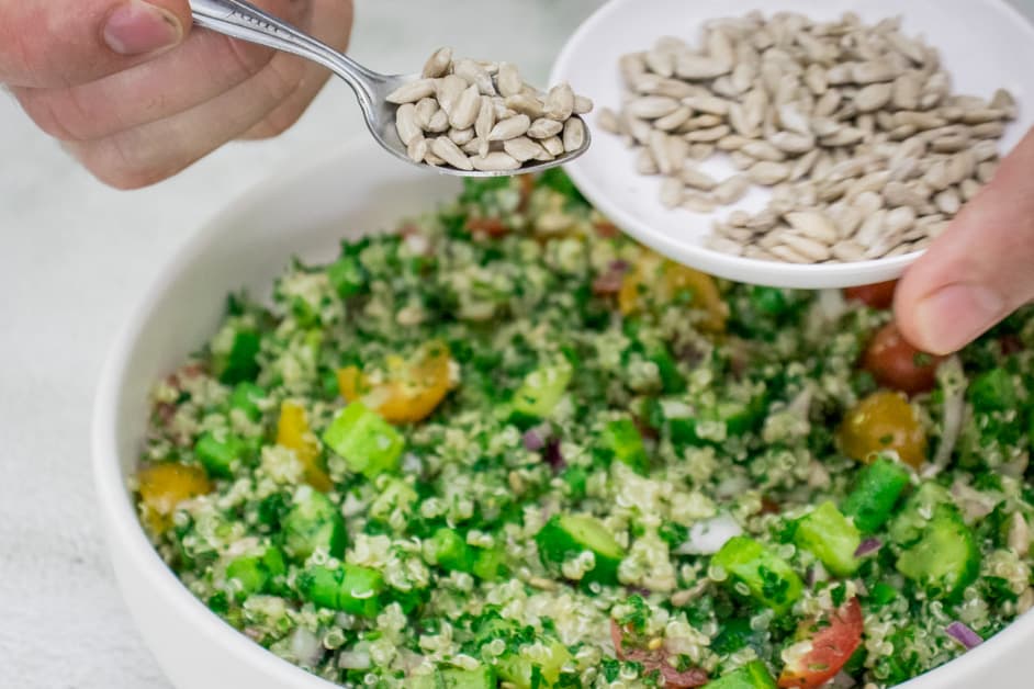 adding sunflower seeds to the tabbouleh
