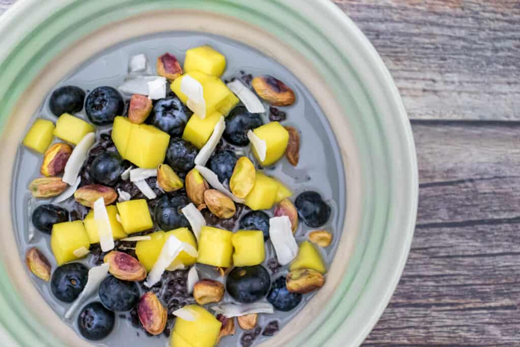 black-rice-pudding-with-mango-and-blueberries-served