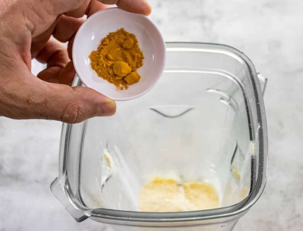 add-the-turmeric-powder-to-the-blender