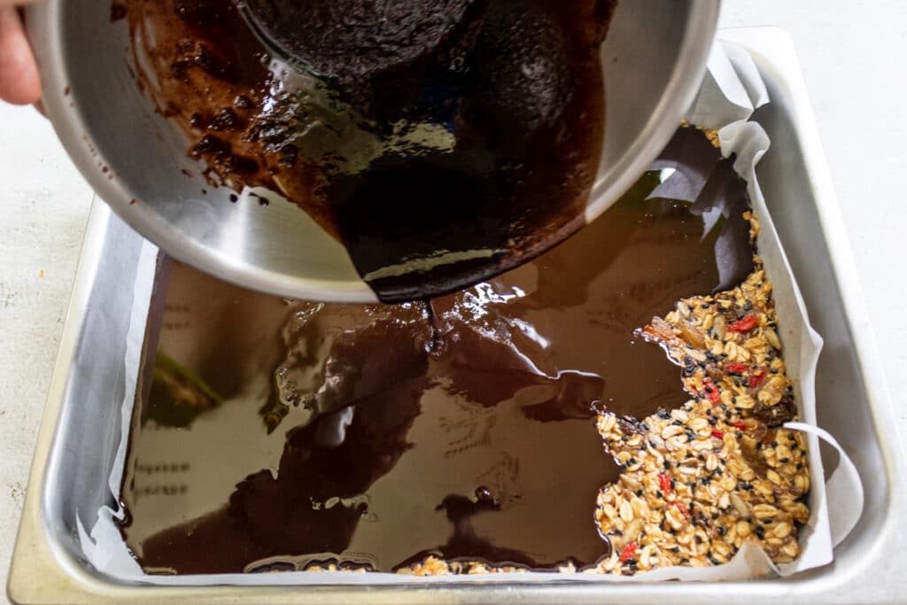 pouring-chocolate-glaze-over-flapjack