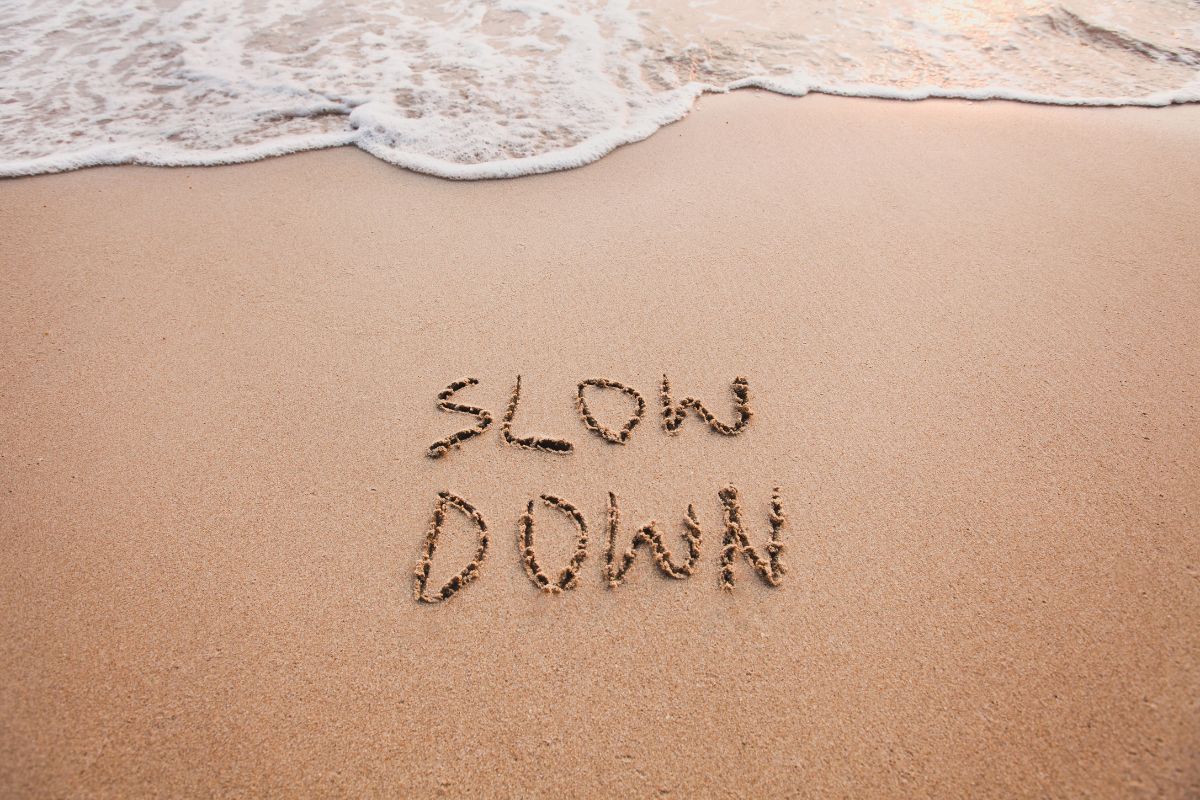 slow-down-drawn-on-the-sand