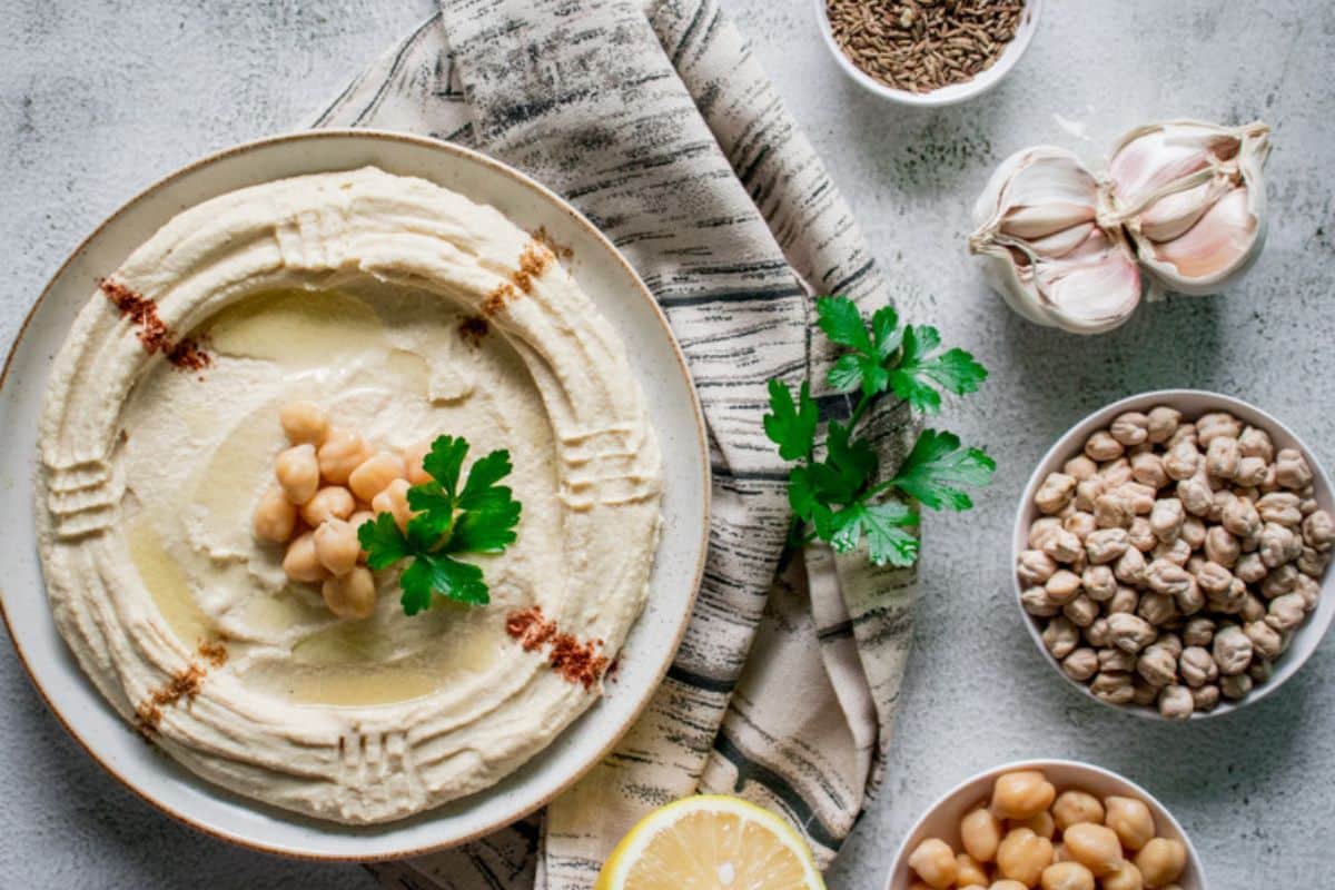 historic chickpea dip laid out with all the healthy ingredients it's composed of.