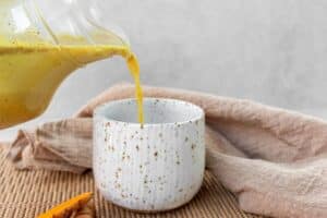 pouring-golden-milk-into-a-mug