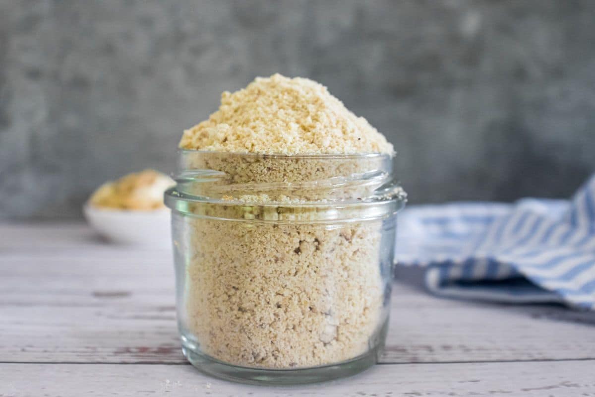 Cashew Parmesan cheese stored in a glass jar as a dairy-free savoury seasoning.