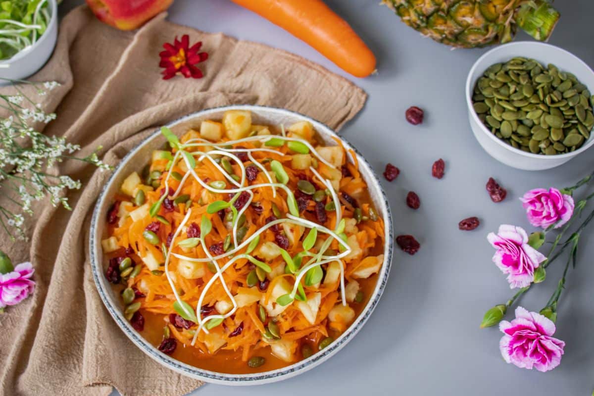 Tropical carrot salad with pineapple, cranberries, pumpkin seeds and lime