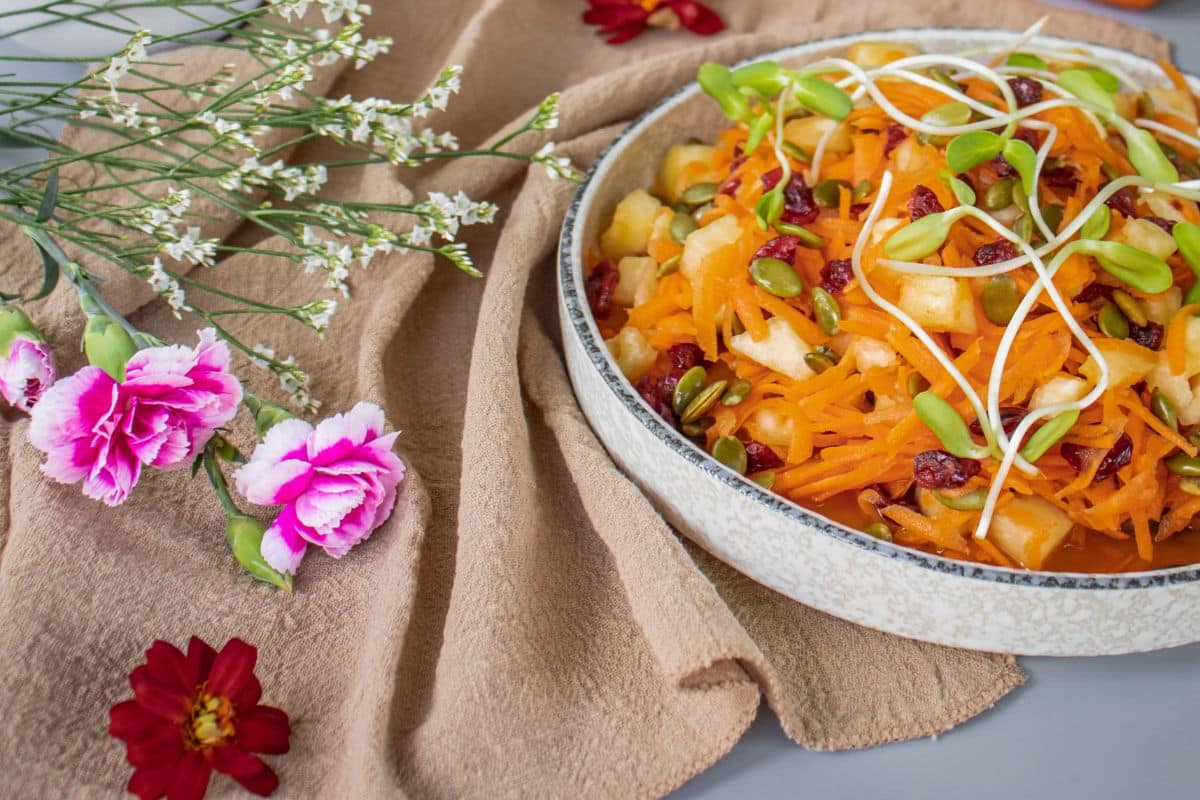 Grated carrot and pineapple salad with dried cranberries and pumpkin seeds