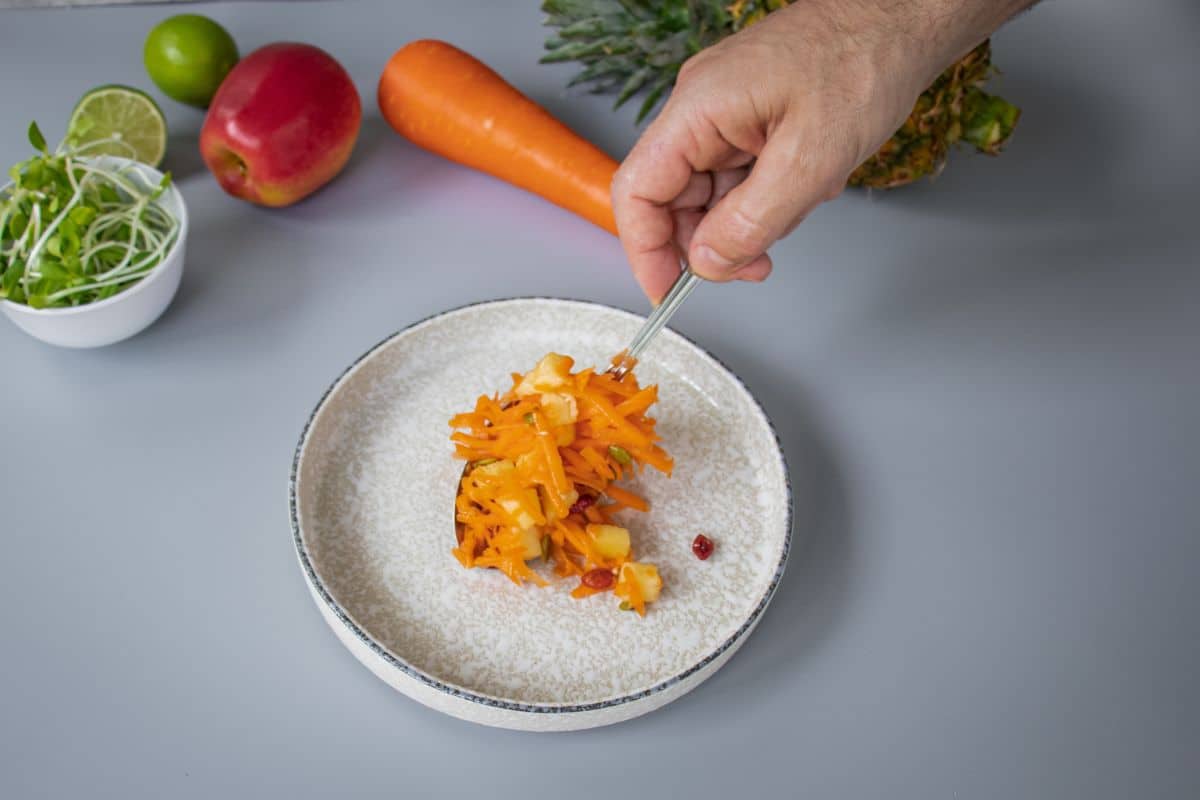 serving the Colourful carrot pineapple salad with apple juice dressing and toasted seeds