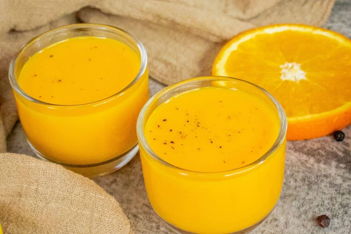 Homemade turmeric shots made with fresh turmeric, ginger, orange, lemon, carrot and black pepper.