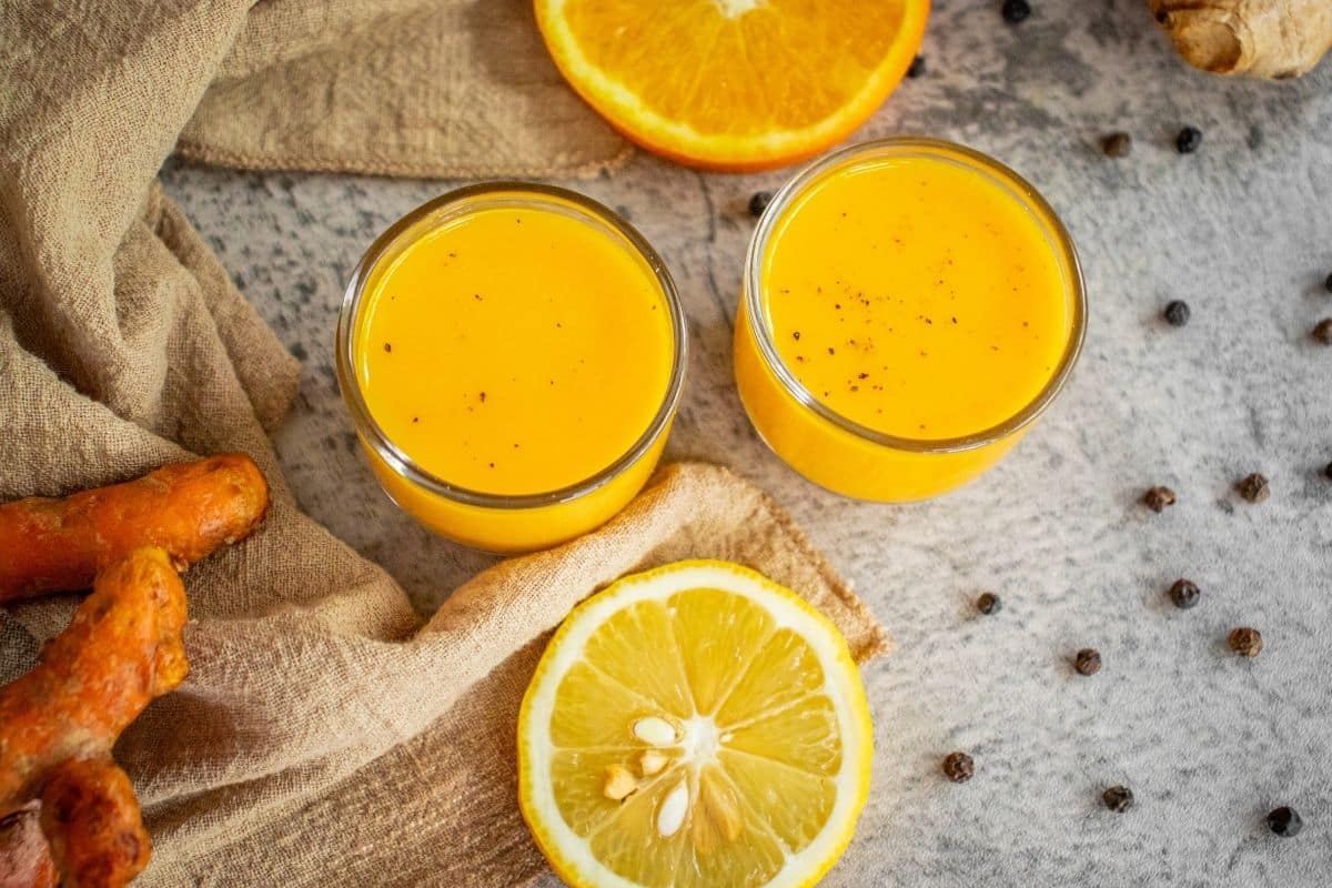 Golden turmeric wellness shots served chilled in small glasses.