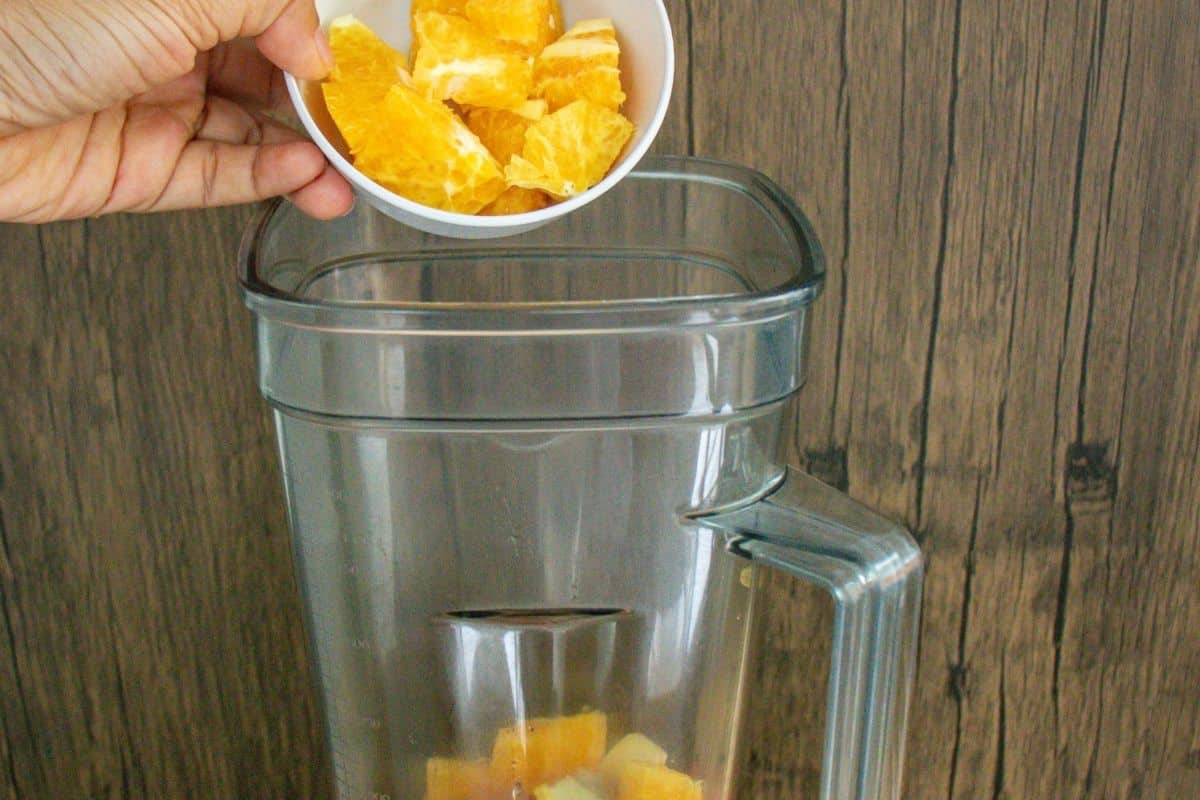 Turmeric-Wellness-Shot-Step-by-Step-4-_-Add-orange-into-a-blender