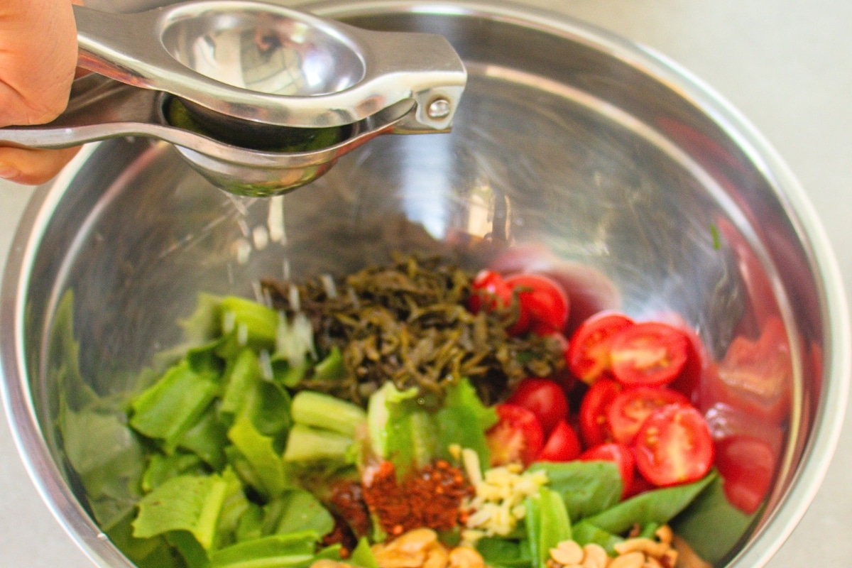 Fresh lime juice squeezed over Burmese Tea Leaf Salad