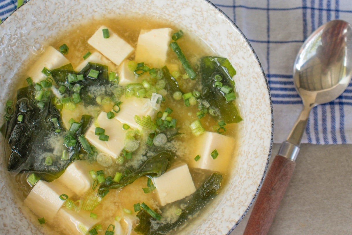 Traditional miso soup served with tofu, seaweed and fresh spring onions