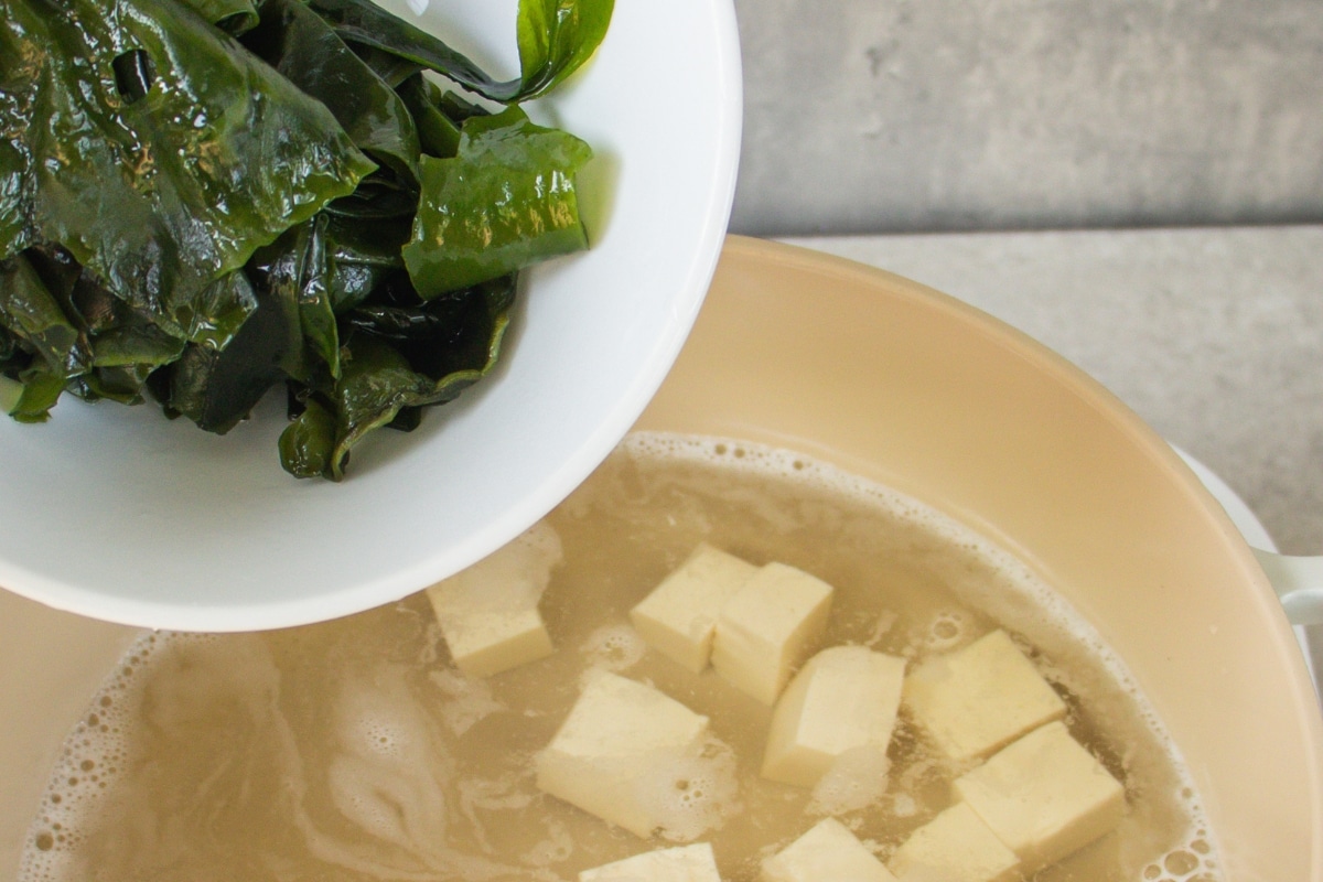 Step 7: Add the wakame - Add the rehydrated wakame to the pot with the tofu.